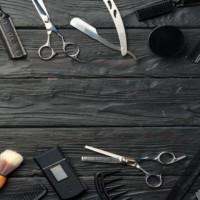herramientas-profesionales-barbero-colocadas-superficie-madera-oscura_93675-163594